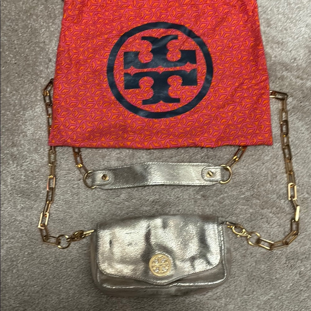 Tory Burch Gold Clutch with Iconic Logo and Luxurious Finish